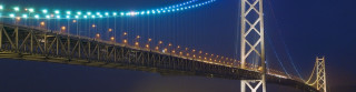 Large bridge night lights span - a boat free wallpaper