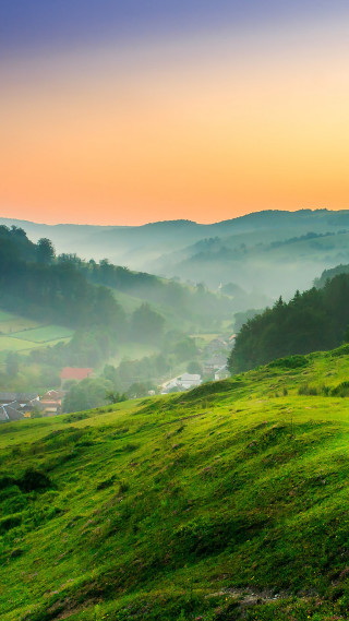 Grassy hill houses sunset fog - free landscape wallpaper