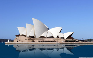 Large building waterfront blue sky - architecture free wallpaper