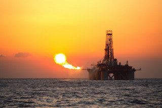Oil rig ocean sunset yellow - orange sun free wallpaper