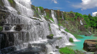 Waterfall blue pool green field - a blue pool in the middle of it free wallpaper
