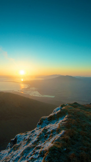 Person sitting hill sunset valley - sunrise free wallpaper