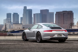 Silver porsche sports car city - skyscraper free wallpaper