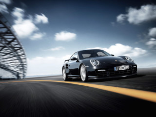 Black porsche driving road tall 2 - a black porsche free wallpaper