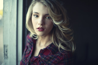 Blonde woman looking out window - her face and shoulders free wallpaper