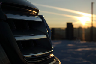 Car parked snow sunset building - a building in the background free wallpaper
