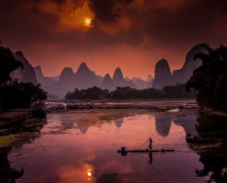 Person rowing boat river sunset - free ship wallpaper