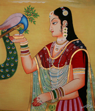 Woman holding peacock arm hand - a tree in the background free wallpaper