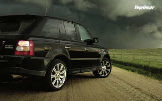Black land rover dirt road - stormy weather free wallpaper