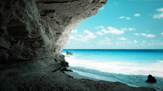 Person rock ocean cliff blue 3 - sense of depth free wallpaper