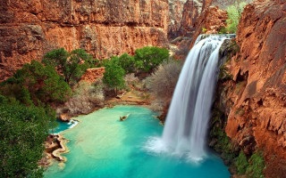 Waterfall man boat cliff blue - a blue pool free wallpaper