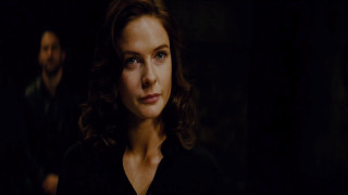 Woman blue eyes dark room - a man in the background free wallpaper