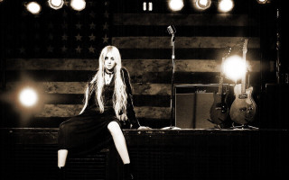 Woman stage microphone guitar flag - dark shadow free wallpaper