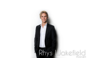 Man suit smiling white wall - his hands in his pockets free wallpaper
