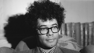 Man tie glasses couch room - free portrait wallpaper