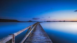 Dock dusk mountain water blue - a mountain in the distance free wallpaper