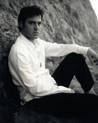 Man sitting rock hands knees - ignacio fernandez rio free wallpaper