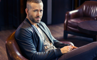 Man sitting chair arms crossed 9 - brad holland free wallpaper