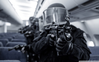 Man gun helmet plane passengers - action scene free wallpaper