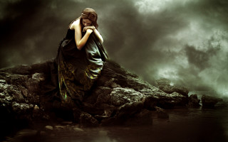 Woman sitting rock water dark - somber free wallpaper