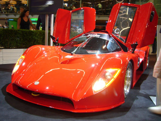Red sports car showroom people 3 - front view free wallpaper