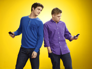 Young men holding cell phones - young free wallpaper