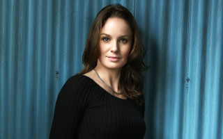 Woman black top blue background - free portrait wallpaper