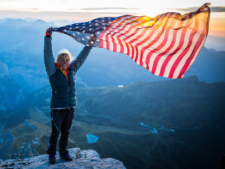 Woman american flag mountain sunset - a view of the valley below free wallpaper