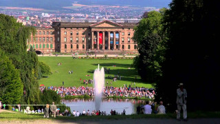 Large building fountain people standing - it in front free wallpaper