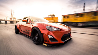 Red sports car street train - a train track free wallpaper