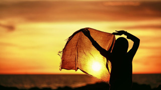Woman scarf sunset ocean sun - the sun setting behind her free wallpaper