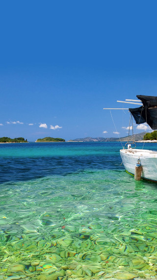 Boat lagoon clear blue water - free beach wallpaper