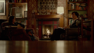 Couple sitting living room fireplace - book free wallpaper