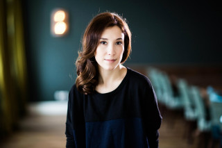 Woman standing room chairs light - studio portrait free wallpaper