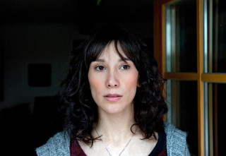 Woman necklace serious look camera 3 - her face and shoulder free wallpaper