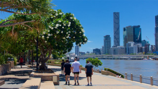 People walking sidewalk river city - a sunny day free wallpaper