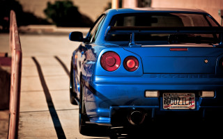 Blue car parked street fence - a blue car free wallpaper