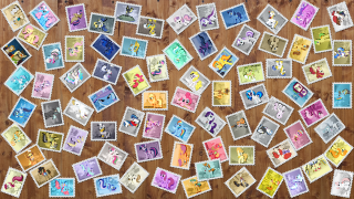 Stamps collection wooden table background - a wooden table top free wallpaper