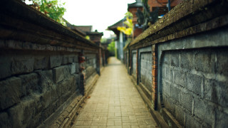 Brick walkway between buildings clock - a brick walkway free wallpaper