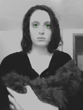 Woman green eyes holding cat - free halloween wallpaper