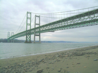 Bridge water beach rocks pebbles - a bridge over a body of water free wallpaper