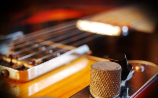 Guitar fretset pickup knobs closeup - shallow free wallpaper