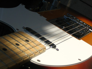 Guitar white neck black pickup 2 - a close up of a guitar free wallpaper
