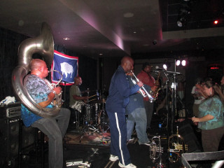 Band playing dark room flag - low free wallpaper