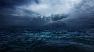 Dark sky ocean clouds boat - the water below free wallpaper