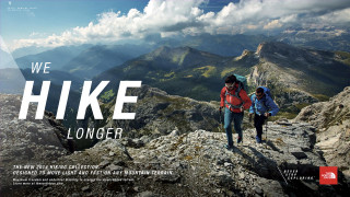 Two people hiking mountain we - side and the words free wallpaper