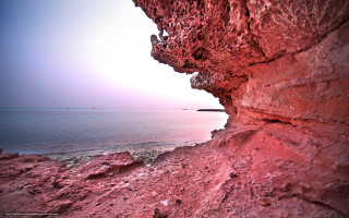 Rocky cliff water boat distance - a rocky cliff free wallpaper