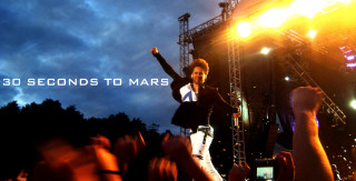 Man standing stage arms in - top of a stage free wallpaper