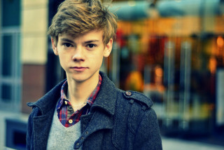Young man serious storefront window - his face and shoulder free wallpaper