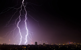 Lightning strike city night time - over a city free wallpaper